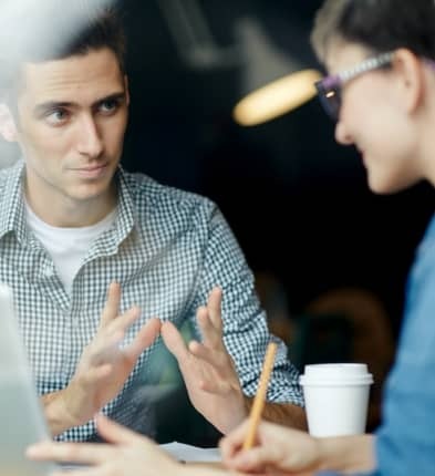 two-people-in-conversation-taking-notes